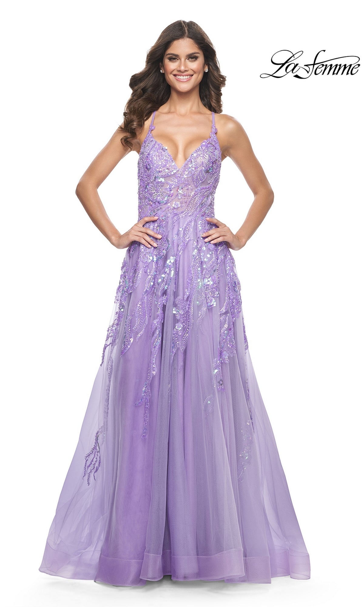A woman stands smiling in the La Femme Sequin-Lace Long A-Line Prom Dress 32032, a lavender, floor-length gown adorned with sequin and floral embellishments.